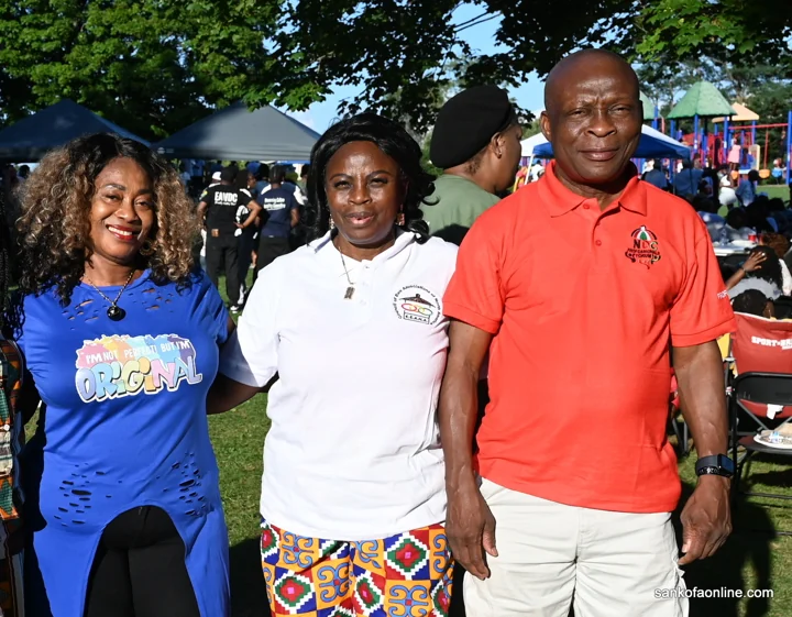 Three convention attendees posing outdoors