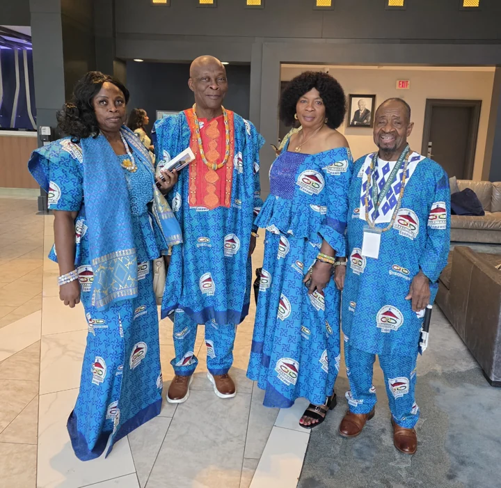 Four convention attendees in coordinated blue attire