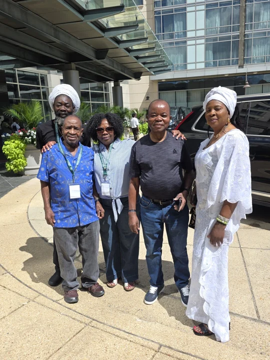 Four convention guests posing outside the hotel