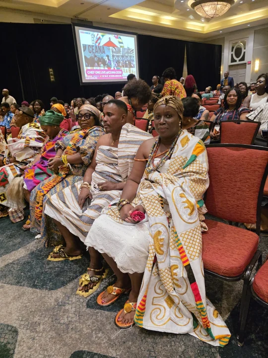 Convention attendees seated in colorful traditional attire