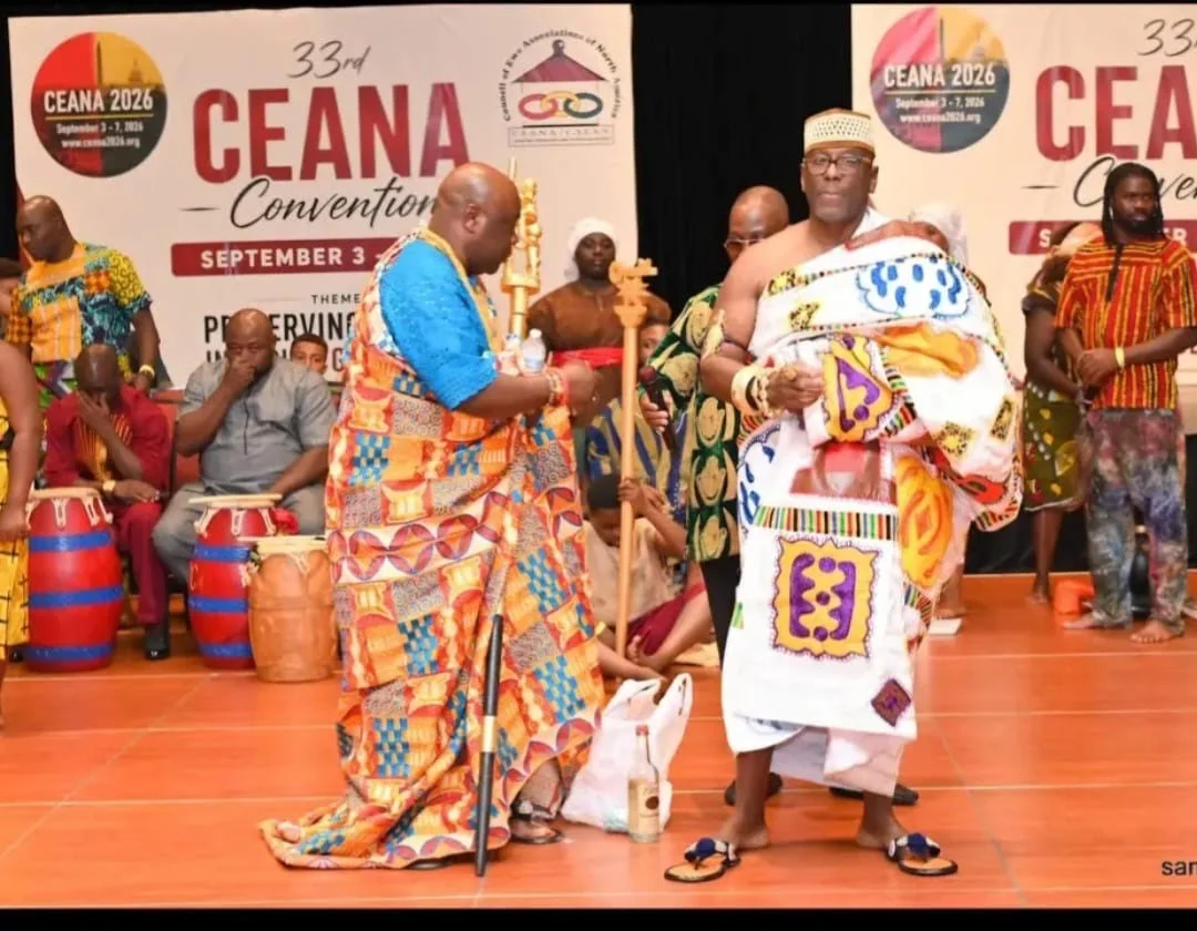 Two men in colorful traditional attire onstage at the CEANA 2026 convention