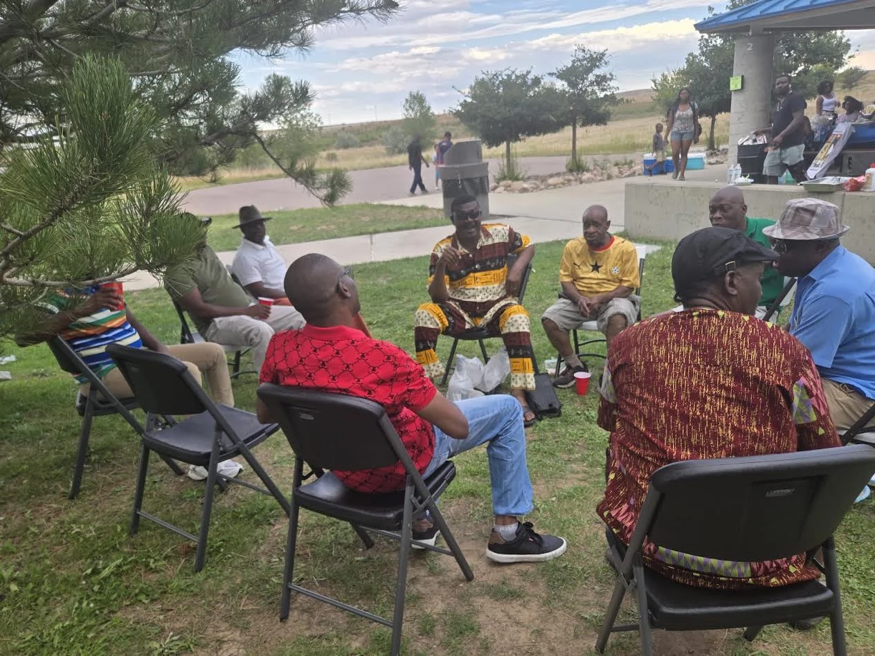 Members relaxing and talking together at Picnic 2026